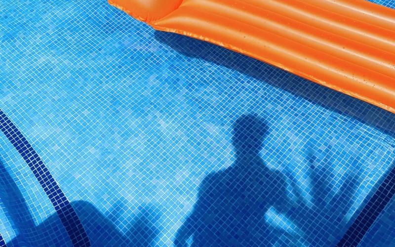 a person's shadow on a pool table